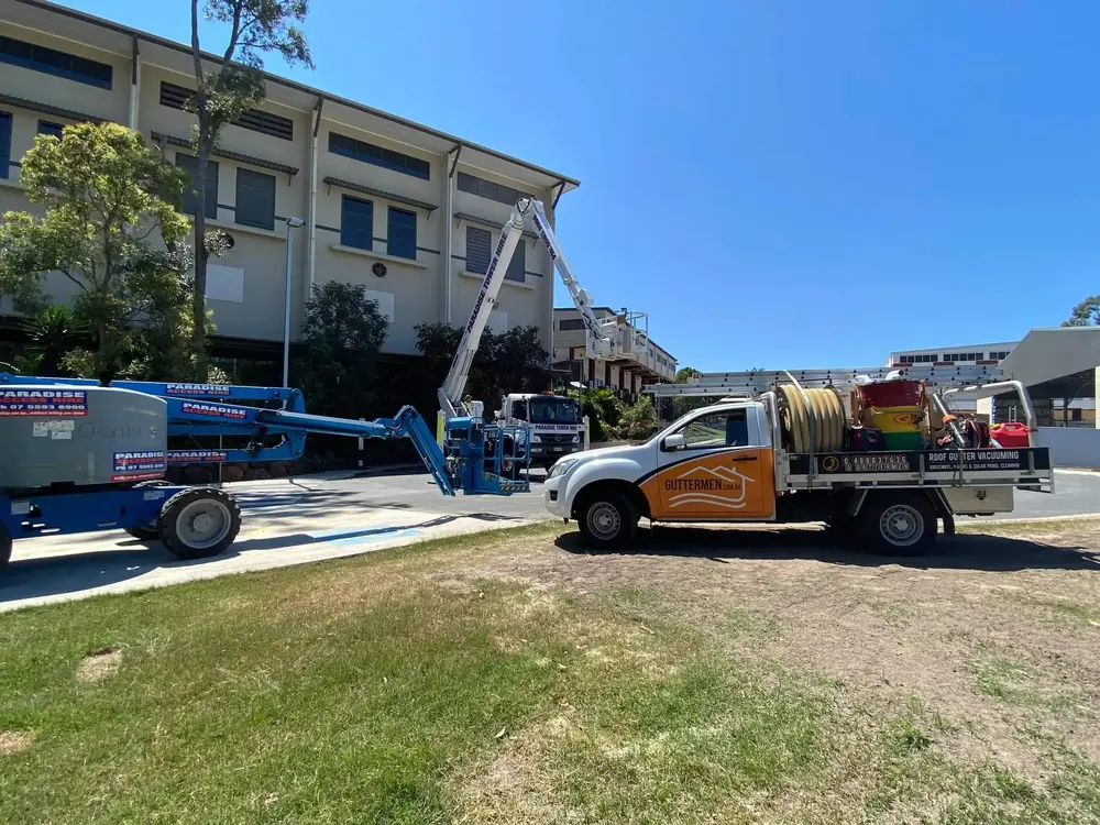 Guttermen ute and elevated boom lift at a commercial Gold Coast job
